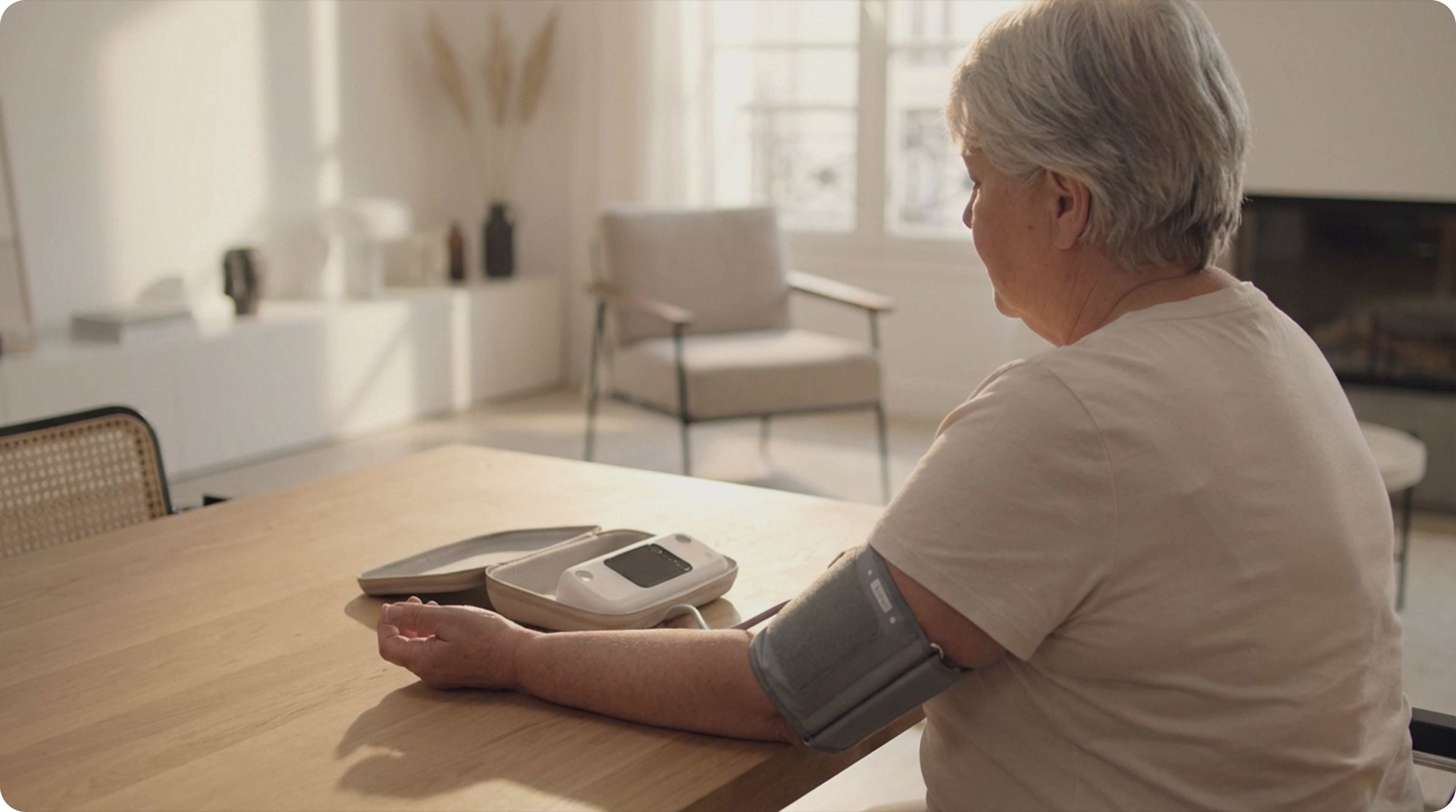 Woman using the BPM Pro 2 blood pressure monitor