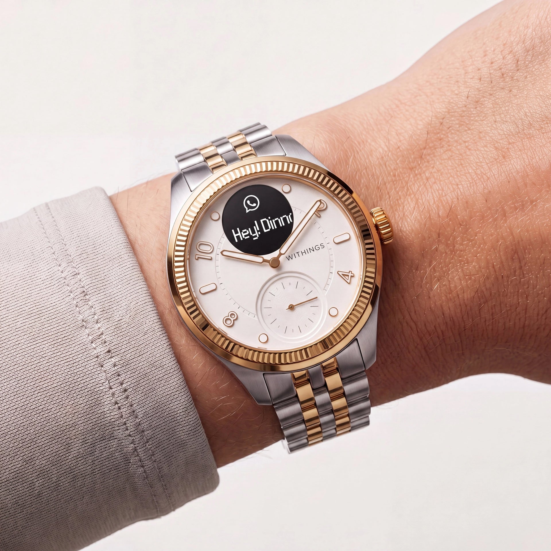 ScanWatch Nova Brilliant — Two-tone gold/silver 39mm — Close-up wrist shot, white dial with WhatsApp notification overlay, two-tone bracelet, studio lighting — wrist, notification, two-tone
