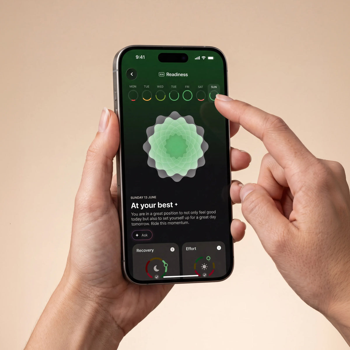 Withings Plus — Readiness Screen — Two hands holding an iPhone showing Sunday June 13 readiness score, green mandala visual, dark background — app ui, hands, readiness, green