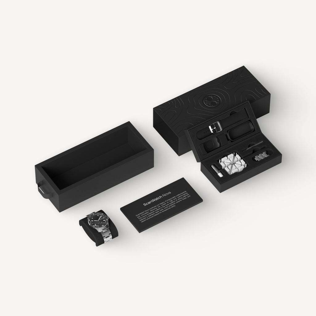 ScanWatch Nova — Black 42mm — Exploded view of matte black packaging with watch, strap, tools and product card on white background — unboxing, box contents, accessories