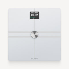 Withings Body Comp — White — Top-down view on neutral background, screen displaying vascular age 28-32 optimal — white, top-down, lit screen, plain background