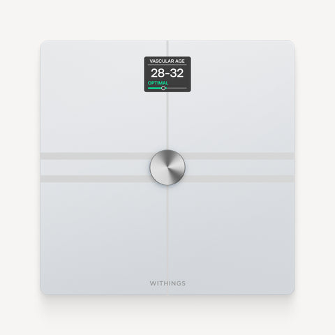 Withings Body Comp — White — Top-down view on neutral background, screen displaying vascular age 28-32 optimal — white, top-down, lit screen, plain background
