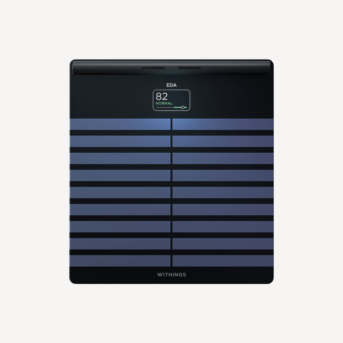 Withings Body Segment — Black — Top-down view on neutral background, screen displaying EDA 82 Normal, blue-black striped surface — top-down, lit screen, plain background