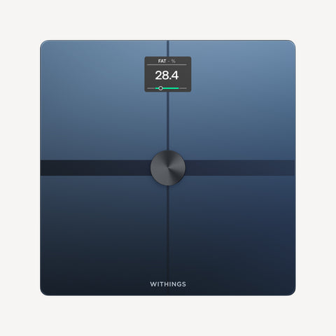 Body Smart — Black — Top-down view on neutral background, screen displaying 28.4% body fat, dark blue surface, metallic center — top-down, black, active screen