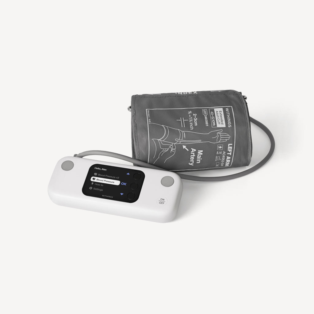 BPM Vision — Connected blood pressure monitor — Three-quarter view, white monitor with color screen and extended grey cuff, plain white background — three-quarter, cuff, color screen, neutral background
