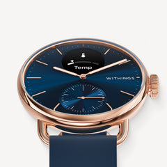 ScanWatch 2 — Blue/Rose Gold 38mm — Three-quarter close-up view, deep blue dial with Temp display, rose gold case, navy silicone strap — three-quarter, close-up, neutral background, blue dial