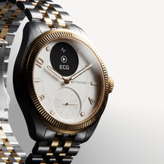 ScanWatch Nova Brilliant — Two-tone gold and steel — Three-quarter view on neutral background, white dial, fluted gold bezel, active ECG screen — three-quarter, two-tone, ECG, jubilee bracelet